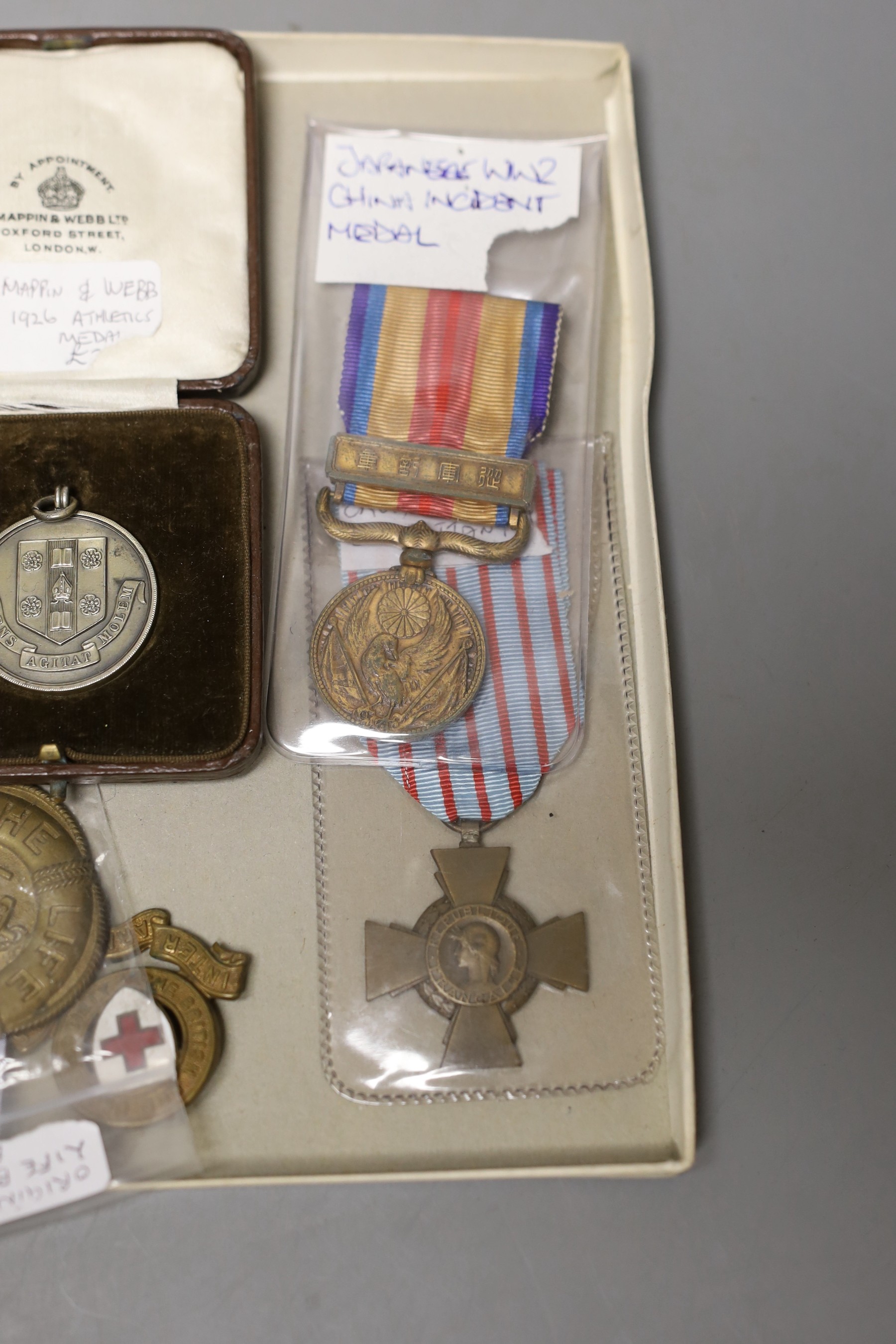 A WWI French Croix du Combattant medal, WWII Japanese China incident medal, other medals, badges, etc.